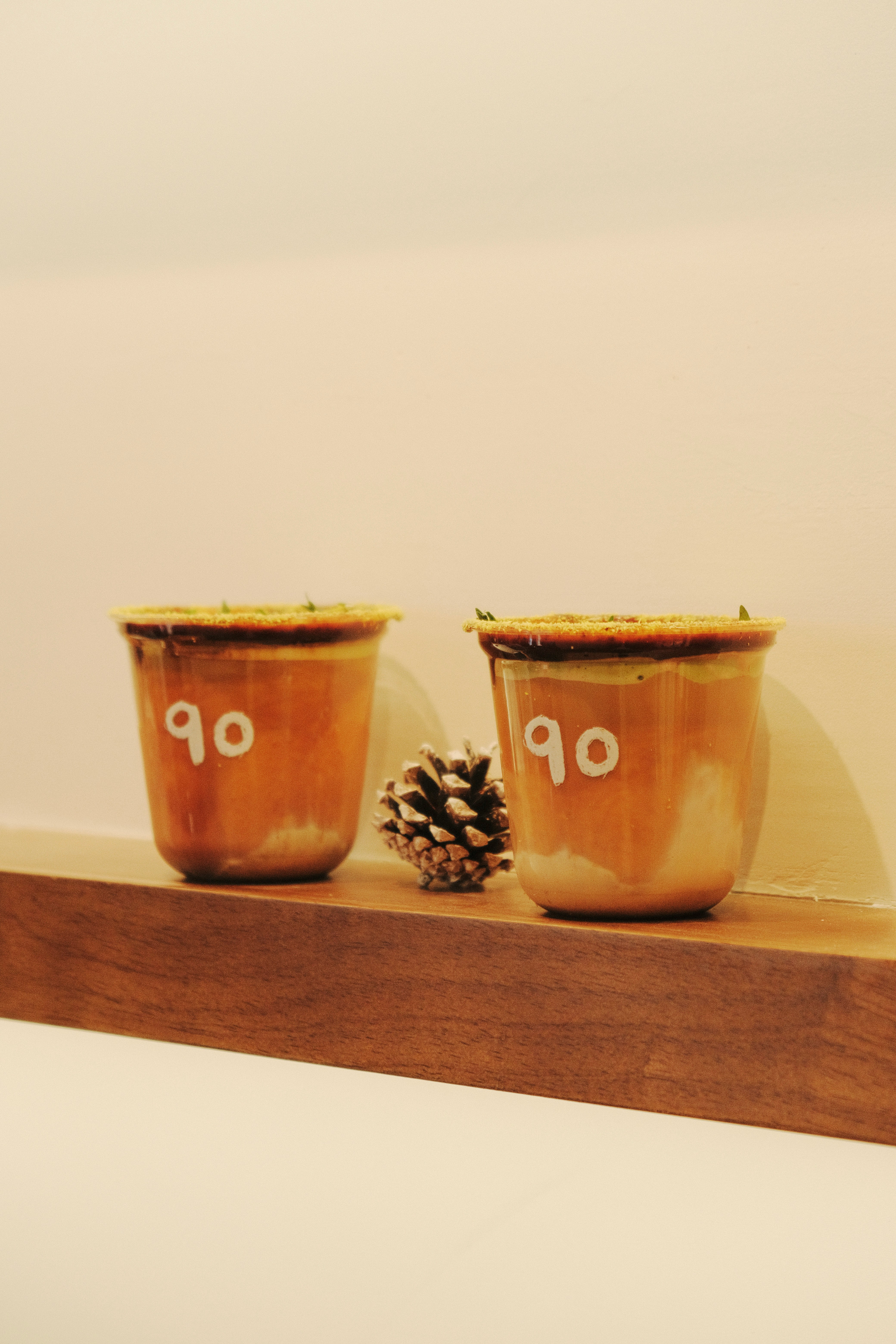 Boost Engagement with Customized Coffee Cups(pic9) Eco-friendly custom ceramic cups with eco motifs on a wooden table.